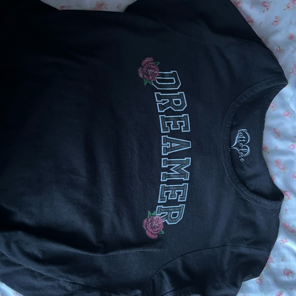 It’s a black shirt that says dreamer on it size medium